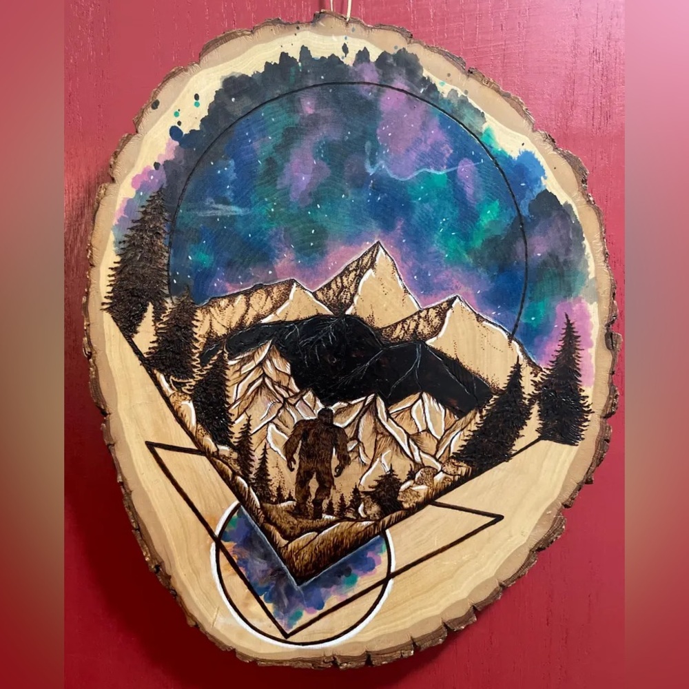 Sasquatch and mountains wood burned and painted round